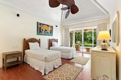 a bedroom with two beds and a ceiling fan at Papagayo Villa w Ocean Views and 2 Private Pools in Nacascolo