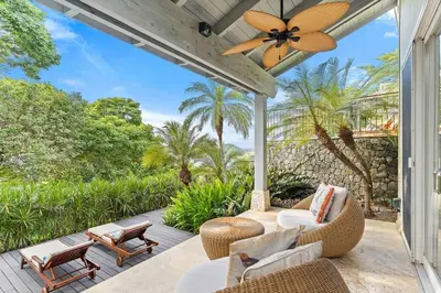 a patio with chairs and a ceiling fan at Papagayo Villa w Ocean Views and 2 Private Pools in Nacascolo