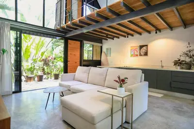 a living room with a white couch and a table at D'Village 8 - 1 bdr loft in Mal País in Mal País