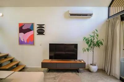 a living room with a tv and a coffee table at D'Village 8 - 1 bdr loft in Mal País in Mal País