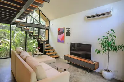 a living room with a couch and a tv at D'Village 8 - 1 bdr loft in Mal País in Mal País
