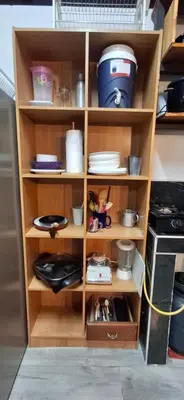a wooden shelf with dishes and other items on it at Villa Don Juan in Rivas