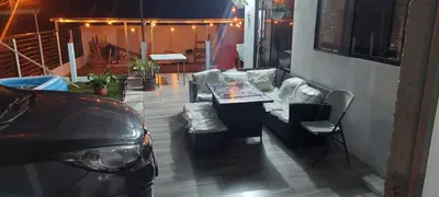 a patio with a couch and a table and a car at Villa Don Juan in Rivas