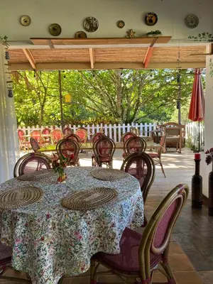 a table and chairs on a patio with a table at Jicote finca de ecoturismo 1 in Paraíso