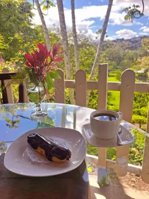 a table with a plate of food and a cup of coffee at Jicote finca de ecoturismo 1 in Paraíso