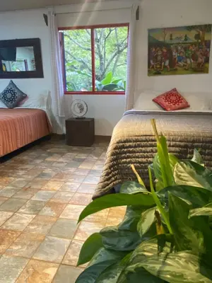 a bedroom with two beds and a window at Jicote finca de ecoturismo 1 in Paraíso
