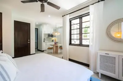a bedroom with a white bed and a window at Studio Ronda 18 - At Las Catalinas in Playa Danta