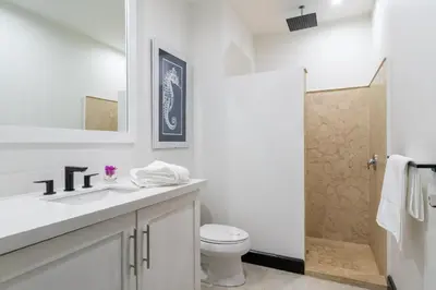 a white bathroom with a toilet and a shower at Studio Ronda 18 - At Las Catalinas in Playa Danta
