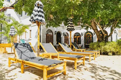 a row of lounge chairs sitting in front of a building at Studio Ronda 18 - At Las Catalinas in Playa Danta