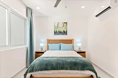 a bedroom with a large bed and a window at Luxury Oceanview Condo with Pool in Tamarindo