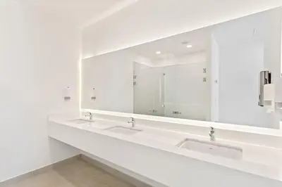 a bathroom with two sinks and a large mirror at Luxury Oceanview Condo with Pool in Tamarindo