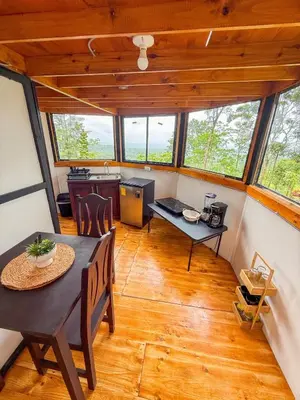 a dining room and kitchen in a tiny house at Selva Partners Chachagua