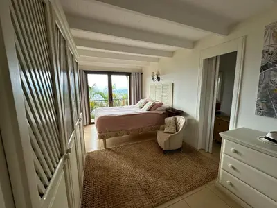 a bedroom with a bed and a window at El Cabanon del Higuerón in Santa Ana