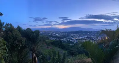 a view of a city from a hill at dusk at El Cabanon del Higuerón in Santa Ana
