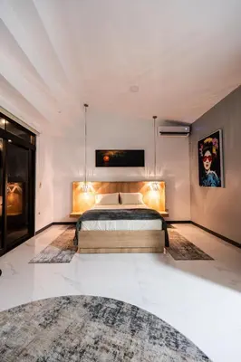 a bedroom with a bed and a tv on the wall at La Danta Lodge - Celeste River in Bijagua