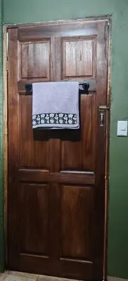 a wooden door with a towel hanging on it at Casa Perezosa in Parrita