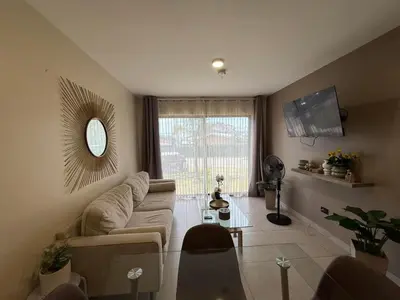 a living room with a couch and a table at Tropical Sunshine in Alajuela City