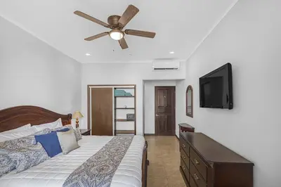 a bedroom with a bed and a ceiling fan at Beachfront view large Condo with Pools PVT luxury patio in great location in Jacó