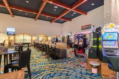 a casino with tables and chairs and slot machines at Beachfront view large Condo with Pools PVT luxury patio in great location in Jacó