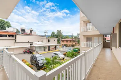an apartment balcony with a view of a parking lot at Beachfront view large Condo with Pools PVT luxury patio in great location in Jacó
