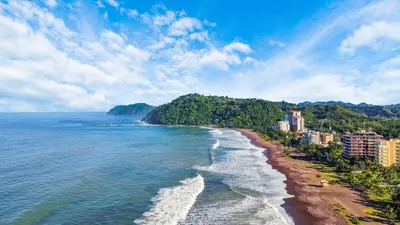 an aerial view of a beach with trees and buildings at Beachfront view large Condo with Pools PVT luxury patio in great location in Jacó