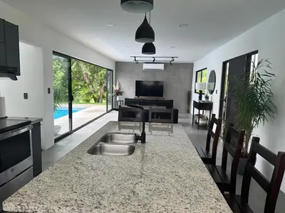 a kitchen and living room with a large counter top at Casa Luna in Santa Cruz