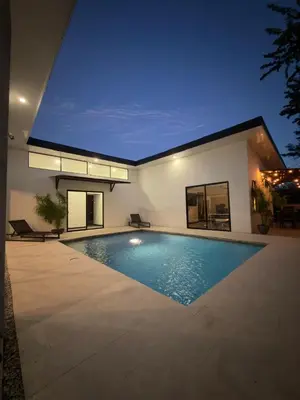 a swimming pool in the backyard of a house at Casa Luna in Santa Cruz