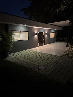 a house with a garage at night at Casa Luna in Santa Cruz