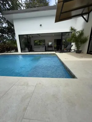 a swimming pool in front of a house at Casa Luna in Santa Cruz