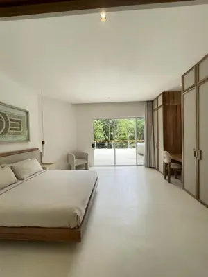 a bedroom with a bed and a desk in it at Villa Bianca in Santa Teresa Beach