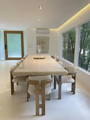 a dining room with a large table and chairs at Villa Bianca in Santa Teresa Beach