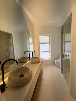 a bathroom with three sinks on a counter at Villa Bianca in Santa Teresa Beach