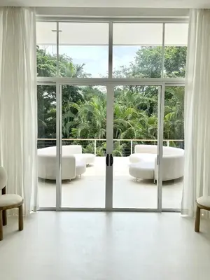 an open living room with a large glass door at Villa Bianca in Santa Teresa Beach
