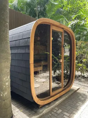 a round wooden mirror sitting on top of a building at Villa Bianca in Santa Teresa Beach
