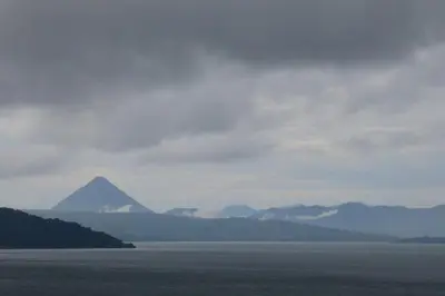 a view of a mountain in the distance of a body of water at Casita Amapola in Tilarán