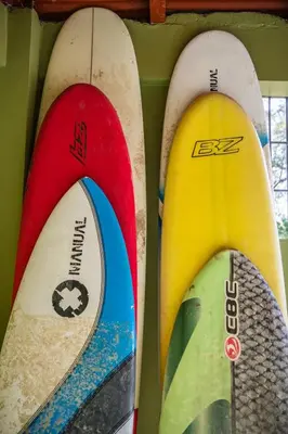 three surfboards are lined up on a wall at Aloha surf Nosara - Kahala Hui Cabanas #1 in Nosara