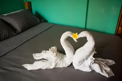 two swans made out of towels on a bed at Aloha surf Nosara - Kahala Hui Cabanas #1 in Nosara