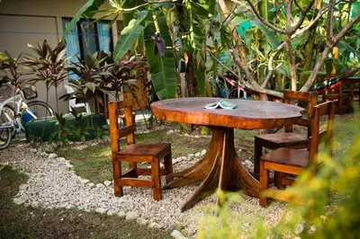 a wooden table and two chairs and a table and chairs at Aloha surf Nosara - Kahala Hui Cabanas #1 in Nosara