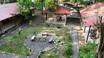 an outdoor garden with a fire pit in the yard at Almendros de Osa Lodge in Uvita