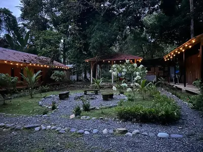 a backyard with a garden with lights on it at Almendros de Osa Lodge in Uvita