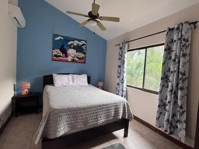 a bedroom with a bed and a ceiling fan at Birds of a Feather 2BR2BA Ocotal Coastal Retreat in Ocotal