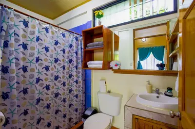 a bathroom with a toilet and a sink and a shower at Aloha Surf Nosara - Kahala Hui Cabins #3 in Nosara