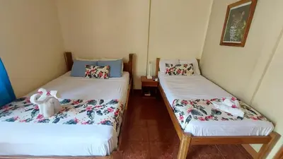 two twin beds in a room with sidx sidx sidx sidx at Aloha Surf Nosara - Kahala Hui Cabins #3 in Nosara