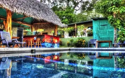a house with a swimming pool in front of a house at Aloha Surf Nosara - Kahala Hui Cabins #4 in Nosara
