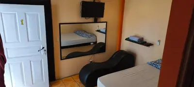 a room with a mirror and a bedroom with a bed at Hotel MANAA in Cariari