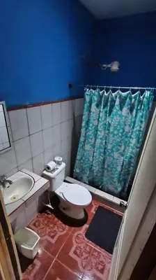 a bathroom with a toilet and a sink at Hotel MANAA in Cariari