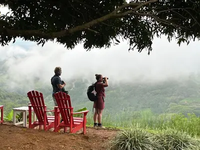 two people taking a picture of the mountains at Wood cozy cabin with ocean views in Boston