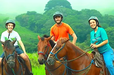 a group of three people riding horses in a field at Wood cozy cabin with ocean views in Boston