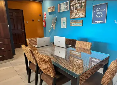 a dining room table with two laptops on it at Hermosa Beach in Tapantí
