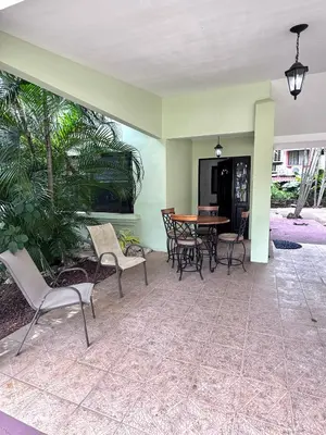 a patio with chairs and a table in a house at Gorgeous Three Bedroom Townhouse in Coco